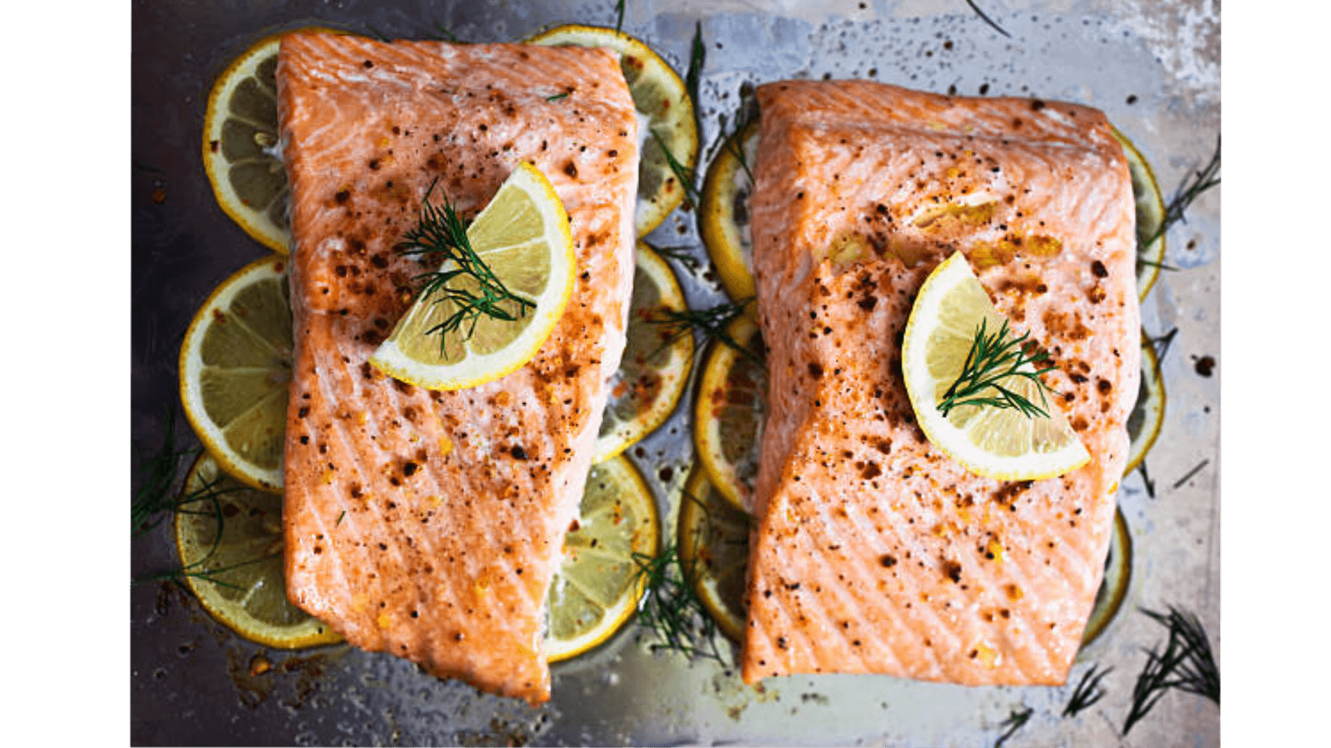 Perfectly cooked salmon fillet from frozen in an air fryer, served on a plate with lemon slices and fresh herbs.