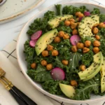 Fresh kale and broccolini on a wooden cutting board.